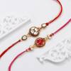 Gift Handcrafted Kundan And Meena Rakhis-Set Of 2