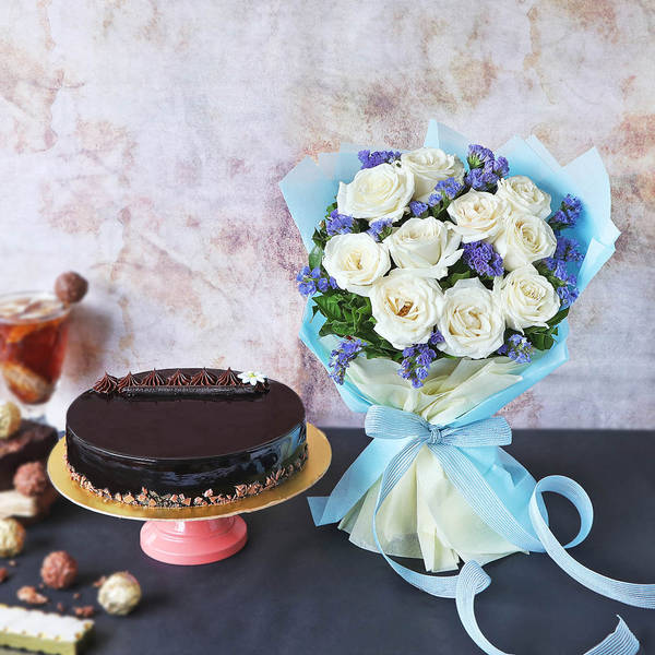 Delicious Truffle Cake With Bunch Of White Roses